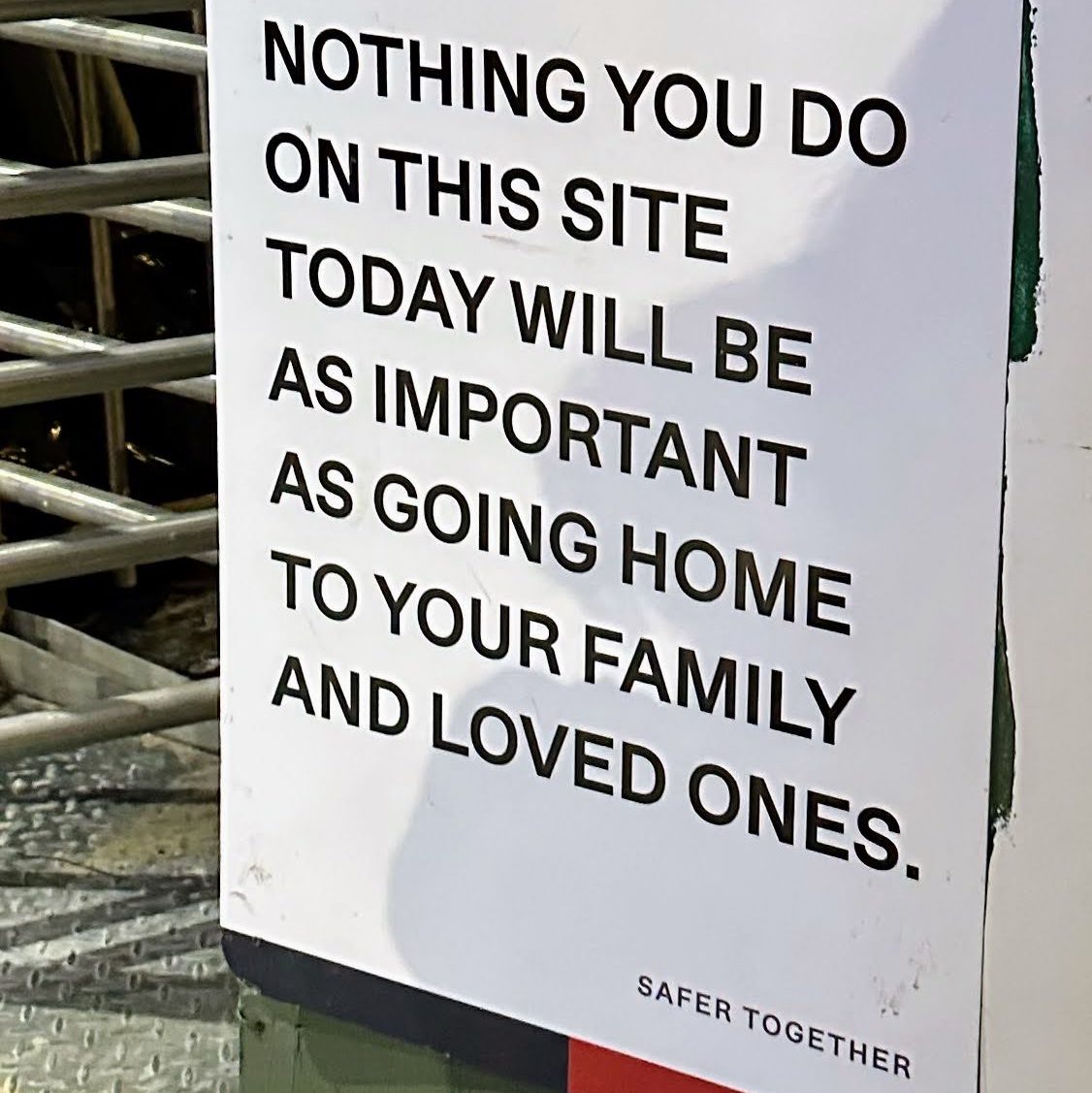 A safety sign emphasizing the importance of prioritizing personal safety over work on a construction site.